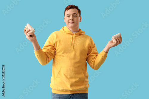 Young man holding doner keb...