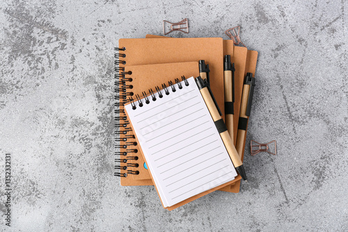 Stack of notebooks, pens an...
