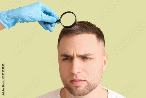 Doctor examining man with h...