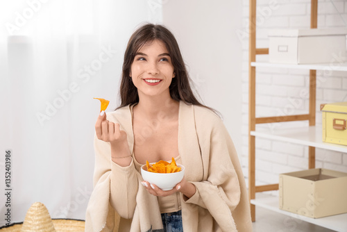 Young woman with nachos at ...