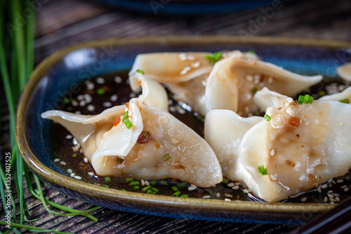 Gyoza. Dumplings. Prepared pieces of dough with meat and vegetable filling, with soy sauce.