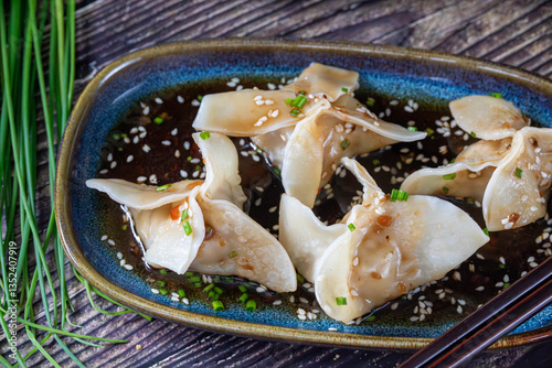 Gyoza. Dumplings. Prepared pieces of dough with meat and vegetable filling, with soy sauce.
