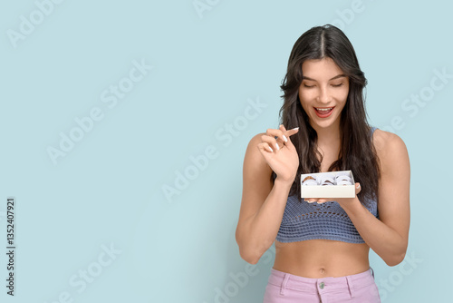Happy young woman with box ...