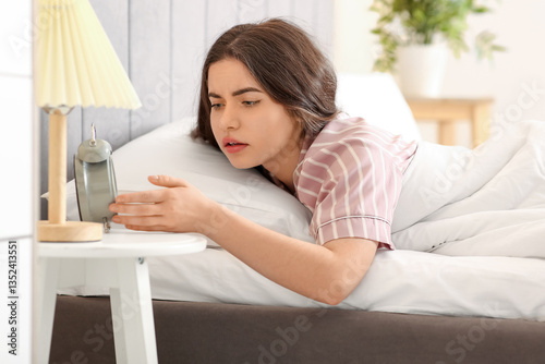 Pretty young woman in bed c...