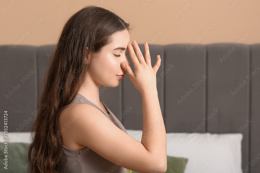 Pretty young woman doing breath practice at home, closeup Pretty young woman doing breath practice at home, closeup