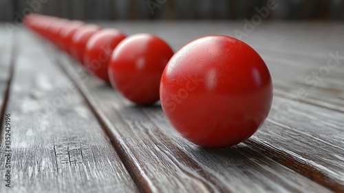 Red spheres in a row on wood