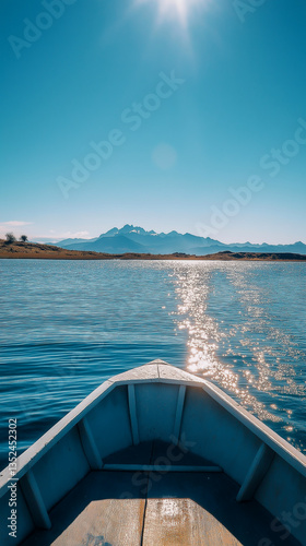 Gliding on tranquil waters with mountains reflecting in the distance under bright sunlight
