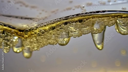 Bubbles in liquid, macro and abstract style, gold and transparent, representing beer or champagne