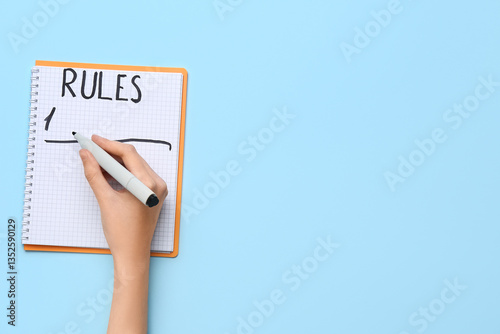 Εκτύπωση καμβά Woman writing rules on notebook against blue background