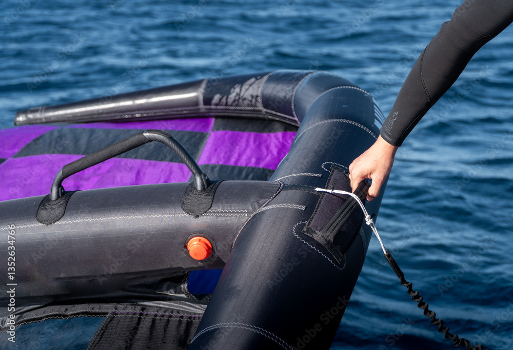 Close-up of a hand gripping the sail for water sports