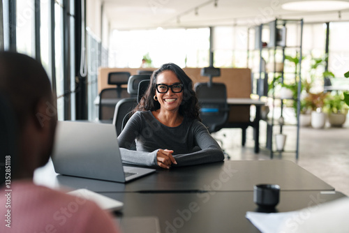 Free Download Confident Young Woman Engaged in Professional Discussion in Bright Modern Office Setting - GFXLoad