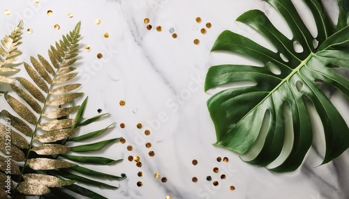 monstera and fern leaves on flat surface with space for text on bright background