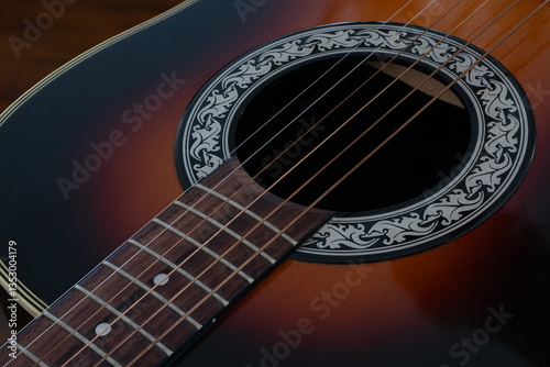 Acoustic guitar close up of sound holes and fret board