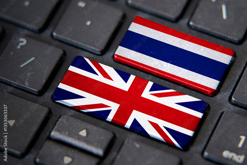 UK and Thailand flags on computer keyboard