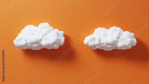 Two white clouds on an orange background photo