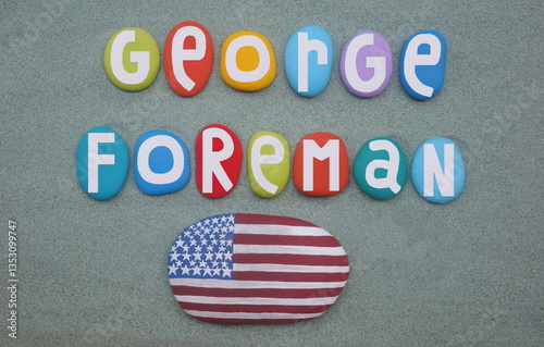 George Foreman, heavyweight boxing legend celebrated with multi colored hand painted stones over green sand