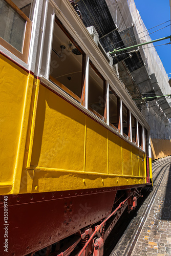 Famous retro yellow funicular in the old town. The yellow funicular operating since 1885, is a tourist attraction. Lisbon, Portugal.