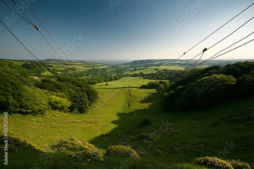 Cable car valley view, green hills, sunny day, pastoral landscape
