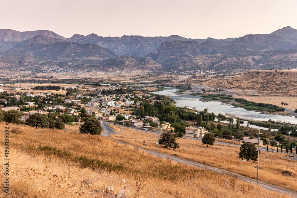 Fototapeta premium Sunset view of Rezan village in Great Zab river valley, Kurdistan Region of Iraq
