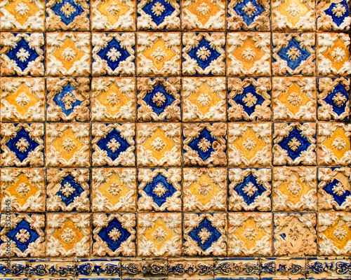 Part of a wall covered with Portuguese tiles in blue, yellow and white relief, in the historic center of the city of São Luís, Maranhão, Brazil