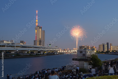 evening scenery of sumida river fireworks festival 2023 with tokyo sky tree seen from shioiri park in minami-senju, arakawa city