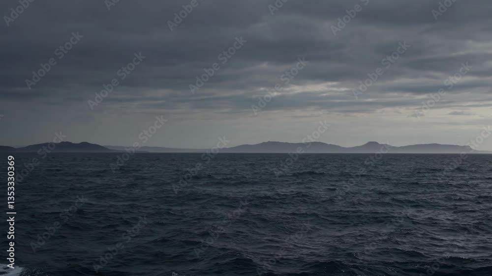 Dramatic seascape video with a wide-angle view, capturing dark clouds over a choppy ocean, evoking a sense of mystery and vastness. Live desktop wallpaper. Dramatic seascape video with a wide-angle view, capturing dark clouds over a choppy ocean, evoking a sense of mystery and vastness. Live desktop wallpaper.