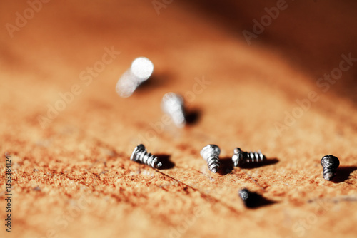 Tiny screws on wooden tabletop