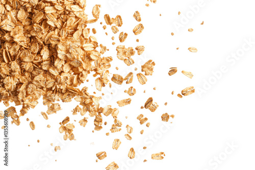 A top view of scattered oat flakes on a black background with some flakes clustered together