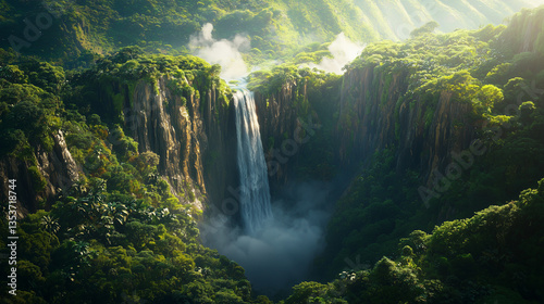 Aerial view of a majestic waterfall plunging into a deep jungle canyon