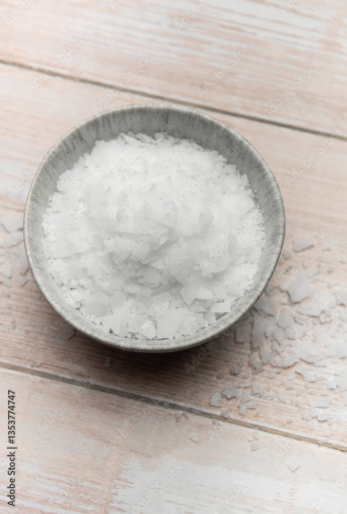 Magnesium flakes in a bowl on wooden table Magnesium flakes in a bowl on wooden table