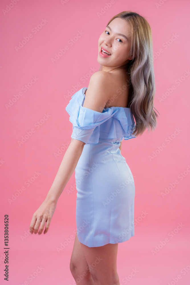 Captured in a well-lit studio shot, a female model with long hair flaunts her latest fashion look, standing against a pink background that enhances her beauty and adds a touch of femininity. Captured in a well-lit studio shot, a female model with long hair flaunts her latest fashion look, standing against a pink background that enhances her beauty and adds a touch of femininity.
