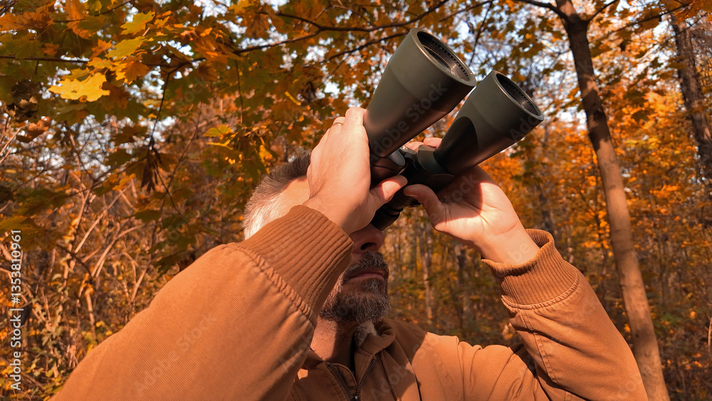 Amateur birdwatcher observing birds and other animals in nature with binoculars.