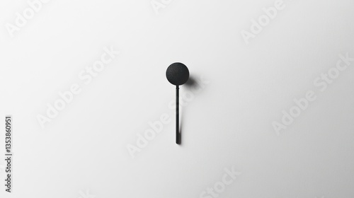 Minimalist black wall hook on white background