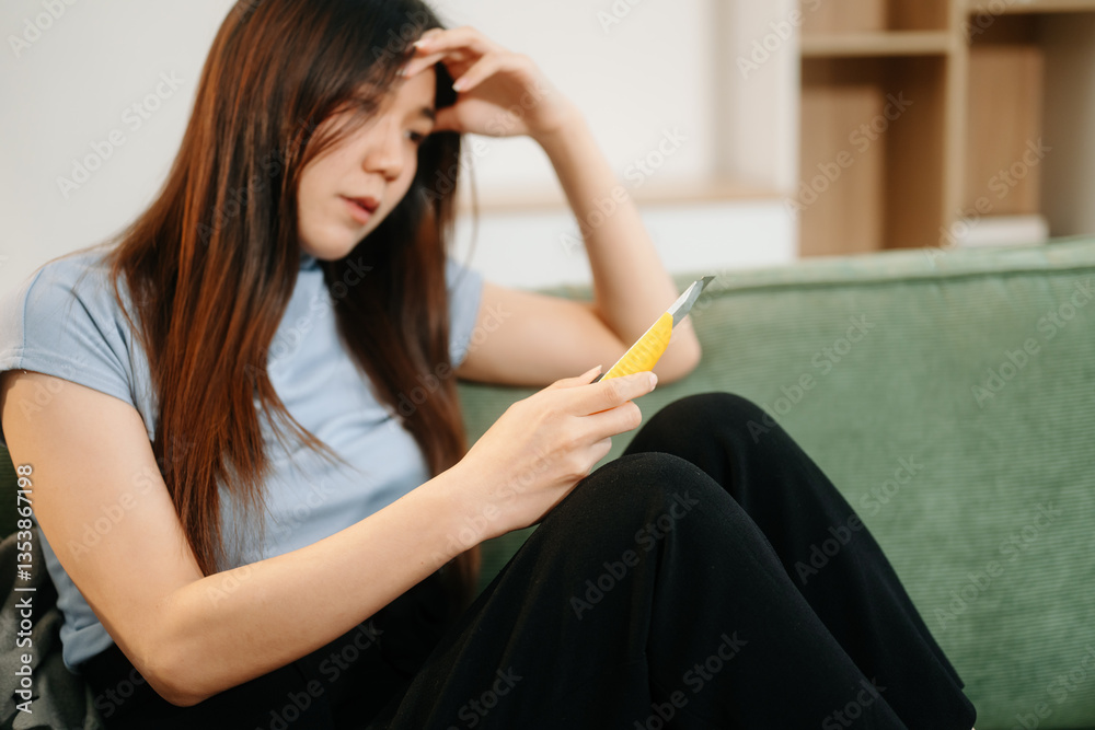 Asian Woman sitting in the sofa with a large number of pills Depressed woman wants to kill herself by drug overdose, depression concept.. Asian Woman sitting in the sofa with a large number of pills Depressed woman wants to kill herself by drug overdose, depression concept..