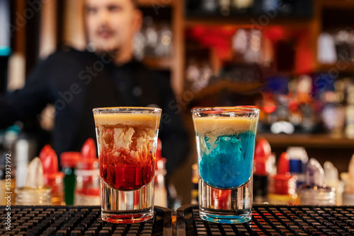 Photography Close up of two monkey brain shot cocktails on bar counter in a bar