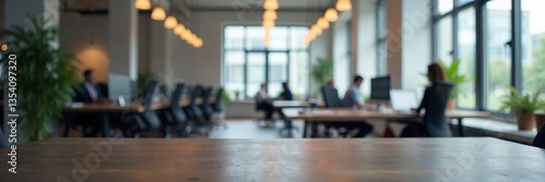 Modern office interior with professionals working at desks and natural lighting.
