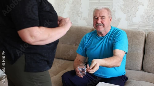 an elderly couple, a husband and wife, lovingly caring for each other as they share medication. highlights the importance of mutual care and the loving bond that exists between partners, especially in