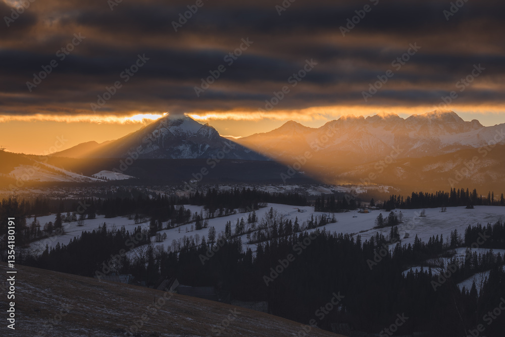 Views from Podhale towards the Tatra Mountains. This winter, there was less snow than usual, revealing more of the rugged landscape. A mix of winter and autumn colors creates a unique seasonal contras