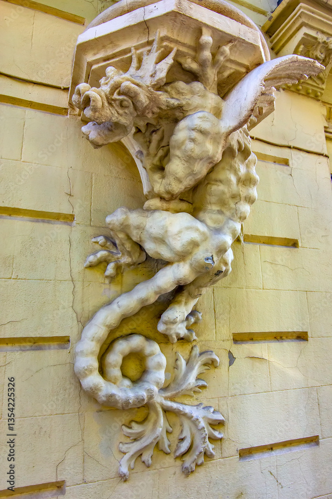 This sculpture of the mythical dragon-like creature is located on a historic building in Don Juan de Austria Street, Valencia, Spain.