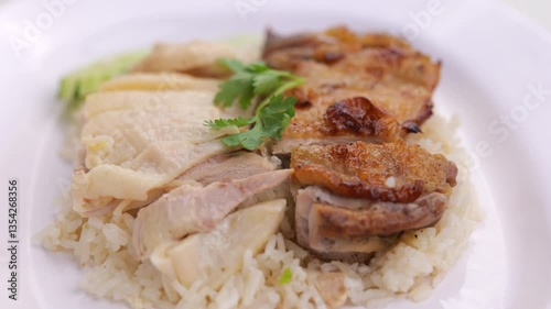 Close-up rotating shot of traditional Thai chicken rice served with boiled and fried chicken. Perfect for food advertisements, cooking content, or Southeast Asian cuisine visuals.