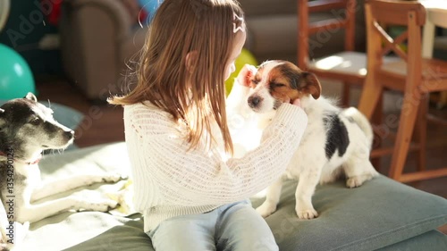 7 year old girl hugs cute little dog