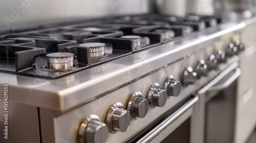 Modern stainless steel gas stove, close-up view, professional kitchen setting