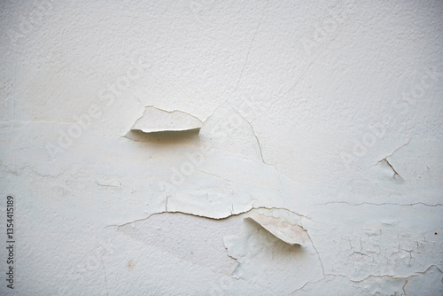 Peeling paint on textured wall creates interesting visual contrast