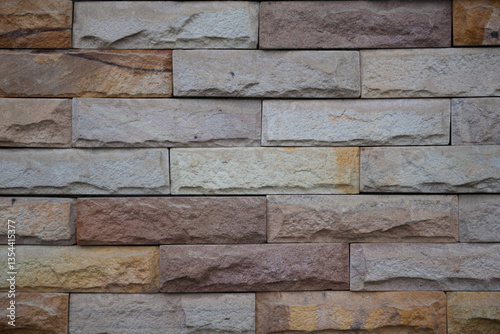 Textured stone wall with various shades of brown and beige, adding warmth to any space