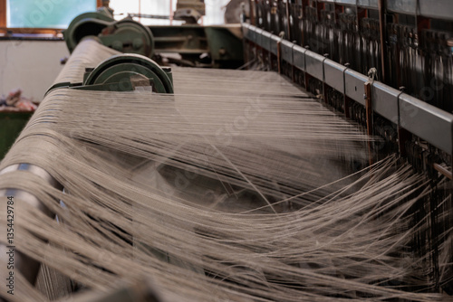 Traditional weaving loom with wool threads in a textile workshop near Umhausen, Tyrol, Austria, March 19, 2025