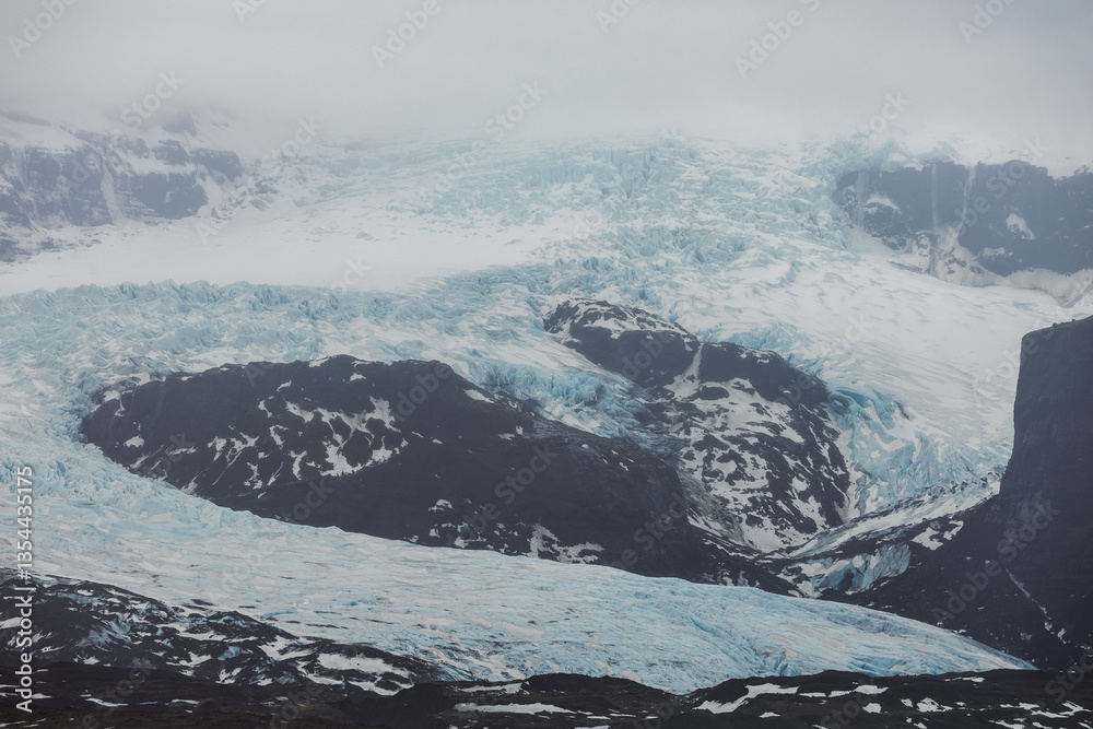 Glacial mountains in Iceland, showcasing rugged peaks and icy landscapes. A breathtaking view of nature's raw power, shaped by time and elements. Perfect for travel, adventure, and nature themes.