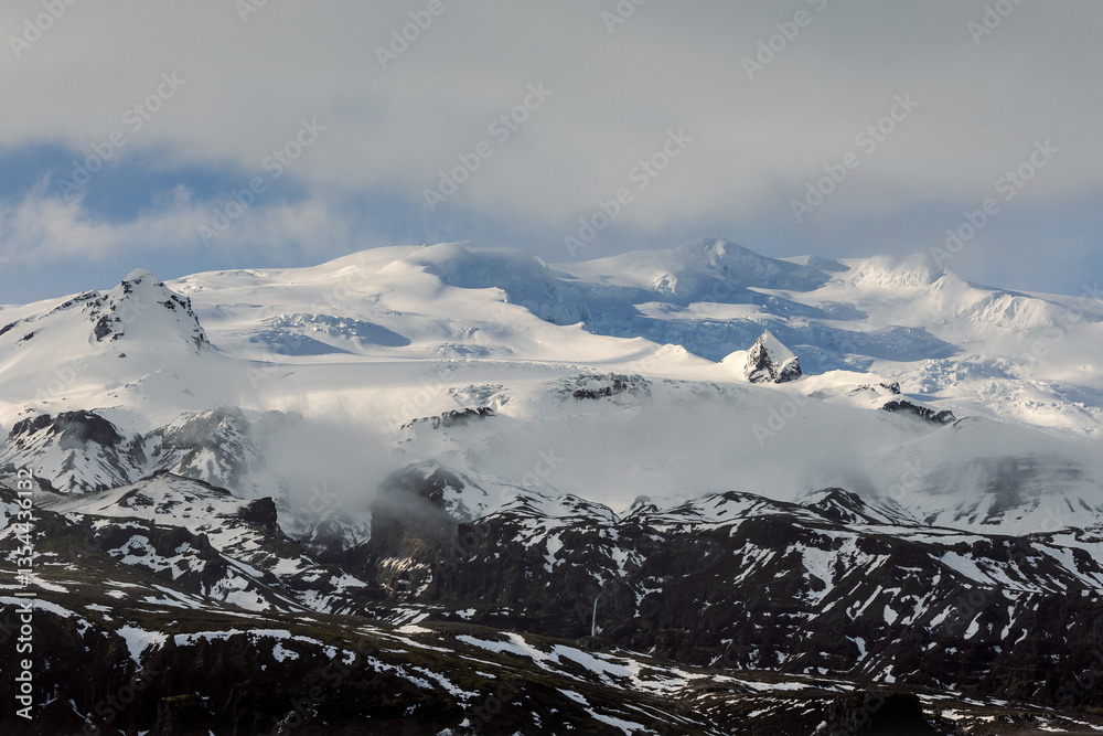 Glacial mountains in Iceland, showcasing rugged peaks and icy landscapes. A breathtaking view of nature's raw power, shaped by time and elements. Perfect for travel, adventure, and nature themes.