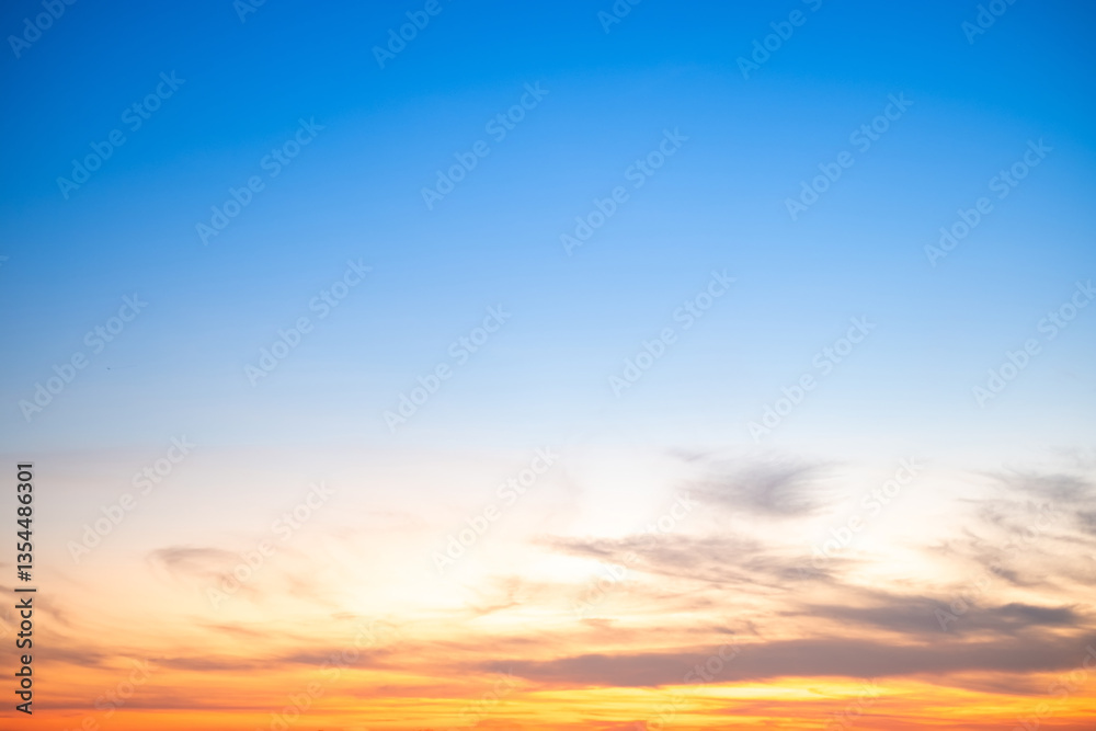 Obraz premium Beautiful , luxury soft gradient orange gold clouds and sunlight on the blue sky perfect for the background, take in evening,Twilight, Large size, high definition landscape photo