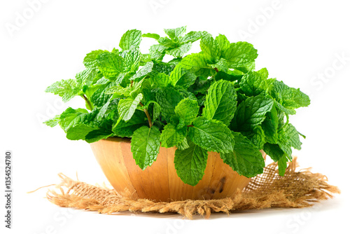 Fresh peppermint in wood bowl isolated on white background. It is widely used in food, beverages, cosmetics, and medicinal products due to its natural menthol content.