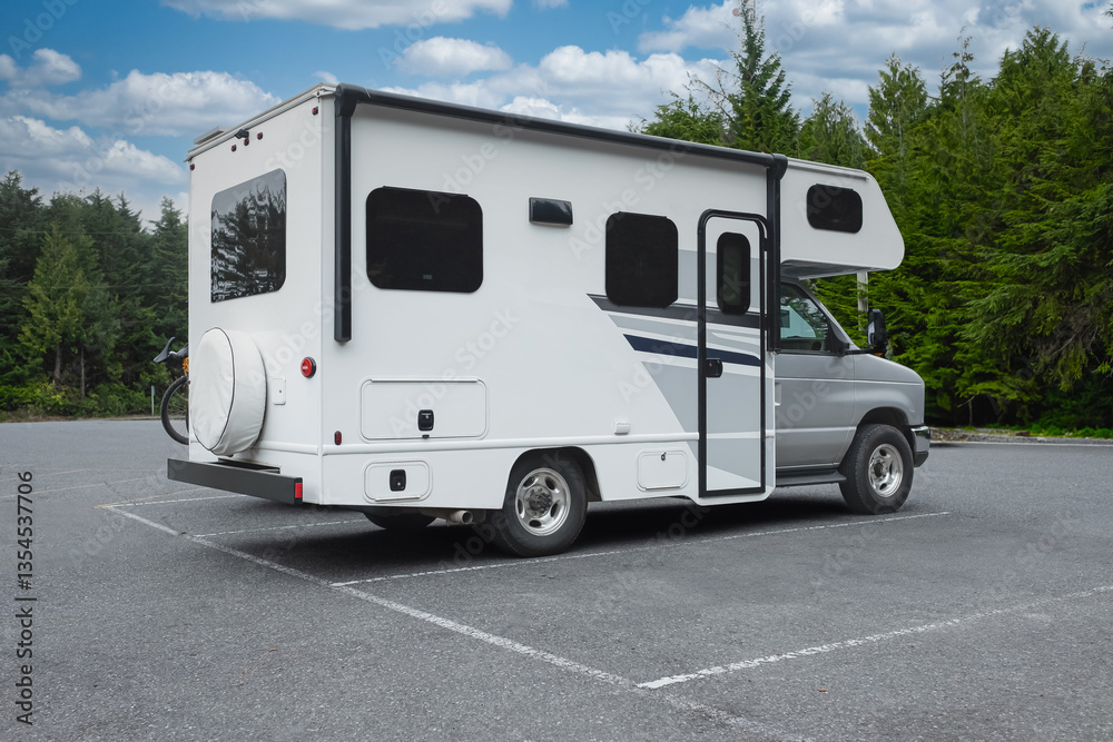 Naklejka premium A motor home camper ready to holidays near lake or river in road trip vacation